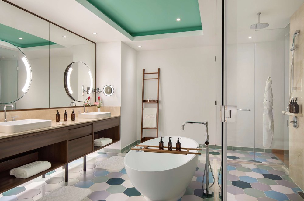 countertop sink with cabinet and white bathtub