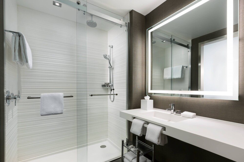 hotel room basin with towel rack and led mirror